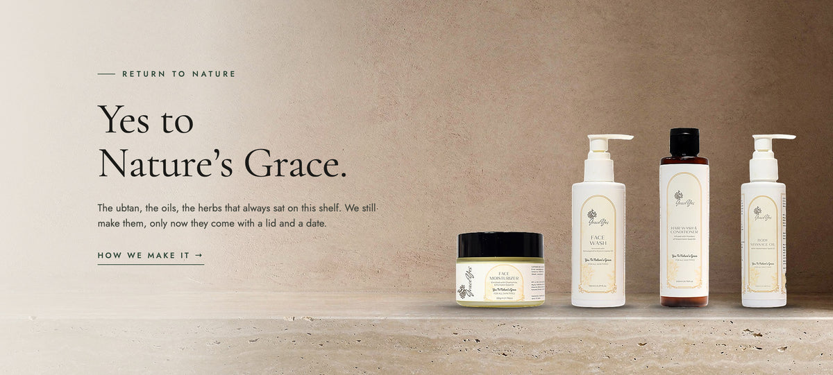 Four old stone jars of ubtan, herbal paste, shikakai and oil becoming GraceYes face wash, face cream, hair wash and body massage oil on an earthy stone bathroom ledge — yes to nature’s grace